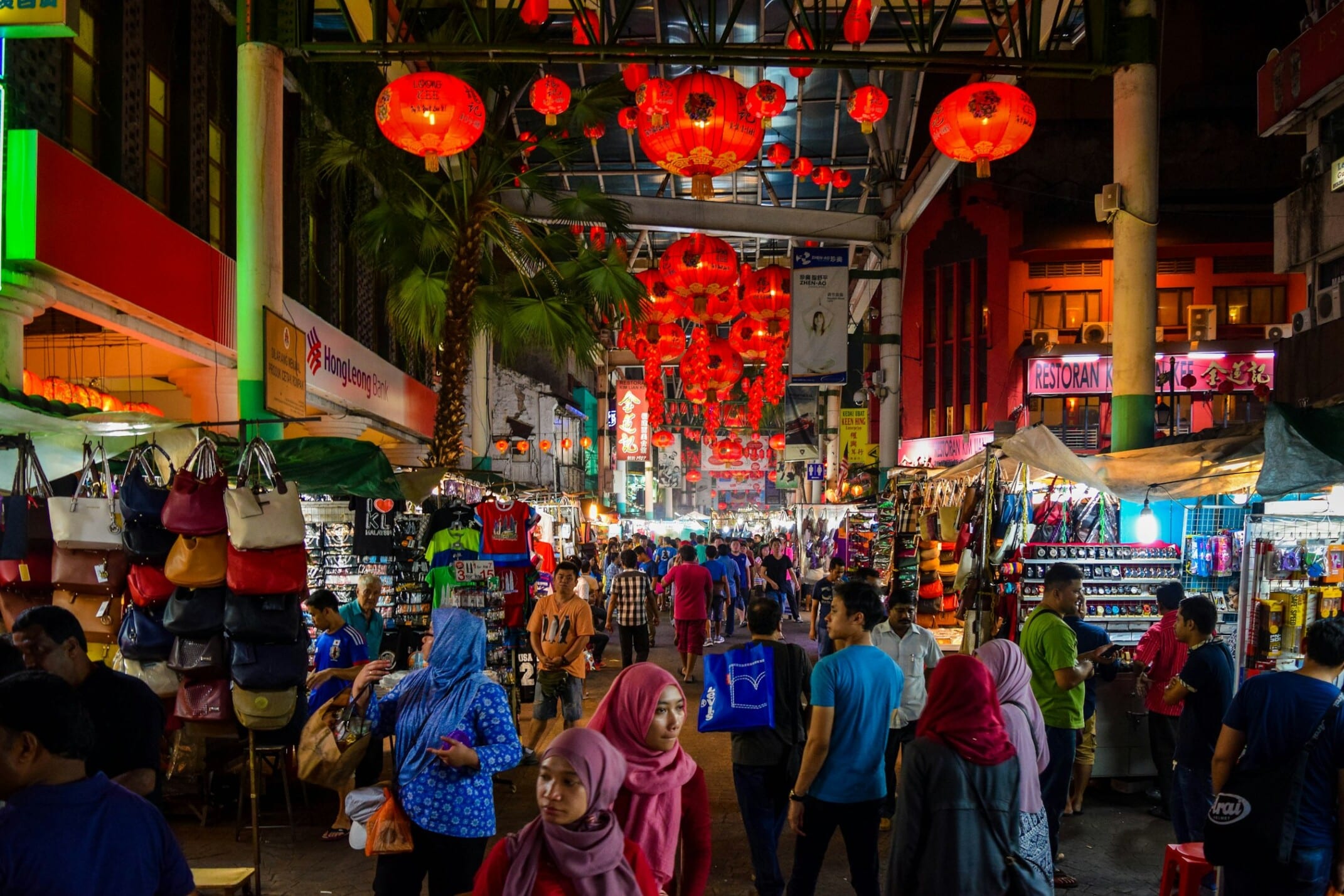 Photo by Ravin Rau people walking on street during nighttime